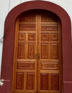 Entrada principal con puerta pivotante de diseño exclusivo en casa de Colonia Americana, Guadalajara.